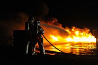 U.S. Air Force firefighters with the 433rd Civil Engineering Squadron (CES) and the 512th CES suppress a controlled fire during training at Fort McCoy, Wis., May 4, 2014, in support of exercise Patriot Warrior.