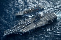 The aircraft carrier USS Carl Vinson (CVN 70) and the fleet replenishment oiler USNS Yukon (T-AO 202) conduct a replenishment at sea in the Pacific Ocean May 20, 2014.