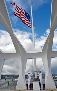 U.S. Navy Electronics Technician 3rd Class Timothy Crossno, left, and Cryptologic Technician Interpretive 3rd Class Adam Crist, assigned to the Joint Base Pearl Harbor-Hickam Honors and Ceremonies flag detail, perform evening colors on the USS Arizona Memorial in Pearl Harbor, Hawaii, May 26, 2014.
