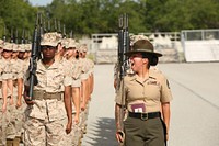 U.S. Marine Corps Staff Sgt. Caroline Chavez, a senior drill instructor assigned to Platoon 4023, November Company, 4th Recruit Training Battalion, commands her platoon during their final drill evaluation, June 25, 2014, at Parris Island, S.C. Chavez directed the recruits to perform a series of precision drill movements.