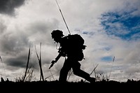 Soldier from the United Kingdom runs for cover during the ongoing simulation battle. Original public domain image from Flickr