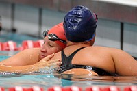 Marine team’s Staff Sgt. Maryann Miller hugs Army team’s Sgt. Nahale Kawaila after Miller won the 100 freestyle swimming finals during the 2014 Warrior Games at the Olympic Training Center in Colorado Springs, Colo. Sept. 30, 2014. Original public domain image from Flickr