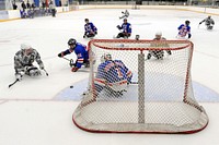 The San Antonio Rampage puts offensive pressure on the USA Warriors sled hockey team during a game in Rockville, Md. Sept. 18, 2014. Original public domain image from Flickr