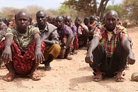 Recruits sit in a training camp for the Somali National Army as they await a visit by Prime Minister Abdiweli Sheikh Ahmed in Baidoa. AMISOM Photo / Ilyas A. Abukar. Original public domain image from Flickr