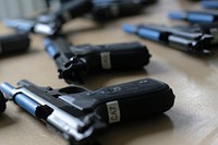 Beretta M9 semi automatic pistols modded with Simunition parts sit on a table prior to training use at Atlantic Cape Community College in Mays Landing, N.J. The weapons were used by New Jersey Air National Guard, U.S. Coast Guard, and local law enforcement officers during Active Shooter Level I training.