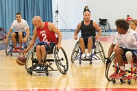 U.S. Marine Corps Staff Sgt. Brad Rich, second from left, scrimmages with the French team in wheelchair basketball Sept. 8, 2014, during the first day of practice for Invictus Games 2014 in London.