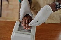 A female officer from Somalia's Custodial Corps is shown how to take fingerprints during a training session organized by UNSOM and UNOPS on biometric registration in Mogadishu, Somalia on 4 March 2015.