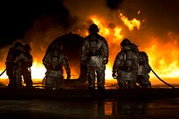 Fire Pit. Marines use water to extinguish a fuel fire at Marine Corps Air Station Futenma during live-burn training.