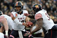 Navy quarterback Keenan Reynolds hands a ball off to Chris Swan during the 115h Army-Navy football game at M&T Stadium in Baltimore, Md. Dec. 13, 2014. Navy beat Army 17-10, extending their winning streak against Army for the 13th straight year. Original public domain image from Flickr