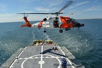 A Coast Guard Air Station Cape Cod helicopter crew works with a Coast Guard Cutter Seneca crew to conduct hoists during Operation Orange Flag in Rhode Island Sound April 1, 2015.