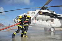 Joint Somali and AMISOM firefighters in a drill conducted upon completion of a refresher training in aviation fire fighting held in Mogadishu, Somalia on April 21, 2015.