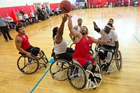 Teams Marine Corps and Army battle for a rebound during wheelchair basketball preliminary rounds for the 2015 Department of Defense Warrior Games at Marine Corps Base Quantico, Va. June 20, 2015.  Original public domain image from <a href="https://www.flickr.com/photos/dodnewsfeatures/18815140228/" target="_blank">Flickr</a>