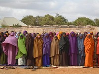 Residents of Baidoa pray at the stadium during the celebrations to mark Eid Al-Fitri in Somalia on July 17, 2015. AMISOM Photo/ Abdikarim Mohamed. Original public domain image from Flickr