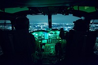 (Right to left) Capt. Brandon Jones and 1st Lt. Jonathan Palka, 459th Airlift Squadron UH-1N Iroquois pilots, use night vision goggles during an exercise above Yokota Air Base, Japan, Aug. 24, 2015.