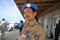 A Police officer from Bangladesh, serving under the United Nations Police attends a ceremony during which a total of 56 vehicles were handed over to the Somali Police Force. The vehicles were donated by the Government of Japan through UNSOM in Mogadishu, Somalia on 9 September 2015. Original public domain image from Flickr