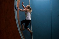 Kim Wienches reaches for the top of the Curved Wall at Pinnacle Parkour Academy on Aug. 26. Original public domain image from Flickr