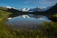 Lake with snowy mountain view. Original public domain image from Flickr