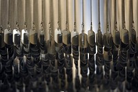 A dog tag chandelier hangs from the ceiling as a part of the décor in the Dog Tag Bakery.