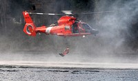A U.S. Coast Guardsmen drops into waters during extraction training as part of Disaster Management Exchange 2015 at Joint Base Lewis-McChord, Wash., Nov. 20, 2015.