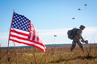 A female paratrooper assigned to the 82nd Airborne Division returns after completing her jump in participation for the 18th Annual Randy Oler Memorial Operation Toy Drop, hosted by U.S. Army Civil Affairs & Psychological Operations Command (Airborne), Dec. 4, 2015, on Sicily Drop Zone at Fort Bragg, N.C. Operation Toy Drop is the world’s largest combined airborne operation and collective training exercise with seven partner-nation paratroopers participating and allows Soldiers the opportunity to help children in need receive toys for the holidays.