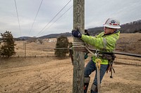 Contract Lineman Brandon Sims climbed utility pole to frame for future stand wire as Virginia's BARC Electric Cooperative leads the way in the Lexington, Va. area installing fiber optic cables to the existing electrical grid, which will bring dependable high-speed broadband to the area for the first time.