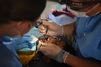U.S. Army Maj. Jax Baylosis, a dentist, and Pfc. Courtney Jeanclaude, a dental assistant, both assigned to the 185th Dental Company, U.S. Army Reserve, extract a tooth from a Guatemalan resident during exercise Beyond the Horizon 2016 in San Pablo, Guatemala, May 14, 2016.
