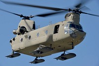 A CH-47 Chinook helicopter flies over a landing zone after dropping off paratroopers assigned to the 4th Infantry Brigade Combat Team (Airborne), 25th Infantry Division, U.S. Army Alaska, and the Japan Ground Self-Defense Force for training at Joint Base Elmendorf-Richardson, Alaska, June 9, 2016, during Exercise Arctic Aurora. Arctic Aurora is a yearly bilateral training exercise involving elements of the Spartan Brigade and the JGSDF, which focuses on strengthening ties between the two by executing combined small unit airborne proficiency operations and basic small arms marksmanship. (U.S. Air Force photo/Justin Connaher). Original public domain image from Flickr