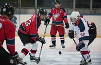 U.S. Air Force Staff Sergeant Brandon Tudball (left) and Sean Carlock (right), members of the Kaiserslautern Military Community Eagles Hockey Team, compete for the puck during a practice match in Zweibrucken, Germany on Mar. 16, 2016.