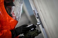 U.S. Army Sgt. Joseph Bercovic, from the New Jersey Army National Guard's 21st Civil Support Team, uses detection gear on a warehouse door during a training proficiency evaluation at the South Jersey Port Corporation on the Camden Waterfront in Camden, N.J., May 24, 2016.