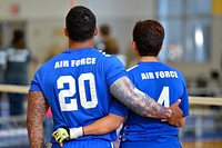 U.S. Air Force Wounded Warrior sitting volleyball athletes embrace during the national anthem at the 2016 Department of Defense Warrior Games held at West Point, N.Y., June 15, 2016.