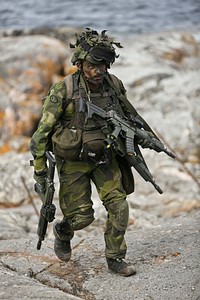 UTO, Sweden (June 11, 2016) A Swedish Marine from 1st Marine Regiment returns to his team after conducting a simulated medical evacuation during the tactical exercise phase of BALTOPS 2016, June 11.