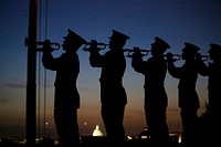 U.S. Marines with 'The Commandant’s Own' U.S. Marine Corps Drum & Bugle Corps play Taps during a Friday Evening Parade at Marine Barracks Washington D.C., May 25, 2018.