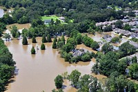 An aerial view taken from an MH-65 Dolphin helicopter shows severe flooding in a residential area of Baton Rouge, LA on Aug. 15, 2016. Coast Guard photo by Petty Officer 1st Class Melissa Leake. Original public domain image from Flickr