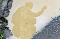 An officer is seen reflected in a pool of muddy water as he gives orders to fellow Soldiers assigned to the 4th Infantry Brigade Combat Team (Airborne), 25th Infantry Division, U.S. Army Alaska, after executing a joint forcible entry exercise at Malemute Drop Zone on Joint Base Elmendorf-Richardson, Alaska, Aug. 23, 2016, as part of Exercise Spartan Agoge. Spartan Agoge is a brigade-level field training exercise that began Aug. 15, and focuses on an array of combat-related tasks from squad live-fire exercises to helicopter air insertion and airborne assault training. (U.S. Air Force photo/Justin Connaher). Original public domain image from Flickr