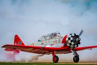 The Aeroshell Aerobatic Team (T-6 Texans) prepare for take off at the EAA AirVenture Oshkosh, Wisconsin.<br/><br/>USDA Photo by Preston Keres<br/><br/>. Original public domain image from <a href="https://www.flickr.com/photos/usdagov/28800040627/" target="_blank" rel="noopener noreferrer nofollow">Flickr</a>