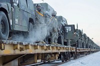 Soldiers assigned to the 1st Stryker Brigade Combat Team, 25th Infantry Division, U.S. Army Alaska, perform railhead operations in sub-zero temperatures on Joint Base Elmendorf-Richardson, Alaska, Jan. 30, 2018. The Fort Wainwright-based Soldiers are off-loading their vehicles and equipment as part of Arctic Thrust, a short-notice rapid deployment exercise. (U.S. Air Force photo/Justin Connaher). Original public domain image from Flickr