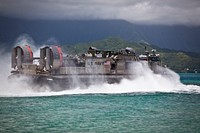 A U.S. Navy Landing Craft Air Cushion (LCAC) assigned to Assault Craft Unit 5 leaves shore during a loading exercise at Landing Zone Westfield aboard Marine Corps Air Station, Kaneohe Bay, Hawaii, July 12th, 2016.