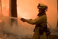 Engine crew member cooling the edge during a burn operation along Henness Ridge; Ferguson Fire, Sierra NF, CA, 2018. Original public domain image from Flickr