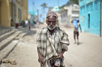 An elderly man stands on the street of Barawe, Somalia, on August 23, 2016.