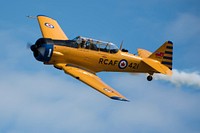 An AT-6 Harvard Mk IV performs an aerial display during the Heritage Flight demonstration at the Arctic Thunder Open House on Joint Base Elmendorf-Richardson, Alaska, July 1, 2018. During the biennial open house, JBER opens its gates to the public and hosts multiple performers including the U.S. Air Force Thunderbirds, JBER Joint Forces Demonstration and the U.S. Air Force F-22 Raptor Demonstration Team. (U.S. Air Force photo by Airman 1st Class Caitlin Russell). Original public domain image from Flickr