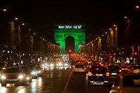 The Arc de Triomphe in Paris, France, is illuminated in green to celebrate the entry into force of the Paris Agreement, the most ambitious climate change agreement in history, on November 4, 2016. [Photo by Jean-Baptiste Gurliat/ Mairie de Paris]. Original public domain image from Flickr
