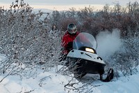 U.S. Marine Corps Capt. Michael Sickels, the inspector-instructor for Detachment Delta, 4th Law Enforcement Battalion, travels via snow machine from Buckland to Deering, Alaska, Nov. 29, 2016. Sickels was part of a team that traveled to Deering to deliver gifts for Alaskan children while participating in Toys for Tots. Toys for Tots is supported by the United States Marine Corps Reserve with a goal of delivering, through a new toy during the holiday season, a message of hope to youngsters that will assist them in becoming responsible, productive and patriotic citizens. (U.S. Air Force photo/Alejandro Pena). Original public domain image from Flickr