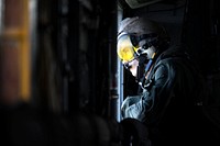 Cpl. Nicholas Luber observes the outside of his CH-53 Super Stallion helicopter for any obstacles as the aircraft takes off from Plaisance-du-Sud, a commune in the Anse-à-Veau Arrondissement in the Nippes Department of Haiti Oct. 18, 2016.