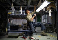 Alaska Air National Guard Staff Sgt. Rafie Baez, a helicopter maintenance mechanic assigned to the 176th Maintenance Squadron, services a HH-60 Pave Hawk helicopter during a routine phase inspection at Joint Base Elmendorf-Richardson, Alaska, Nov. 16, 2016. The HH-60 Pave Hawk helicopter is undergoing a phase inspection to ensure the aircraft is safe and remains mission ready. (U.S. Air Force photo/Alejandro Pena). Original public domain image from Flickr