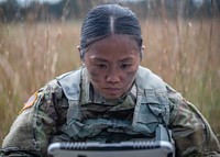 U.S. Army 2nd Lt. Fatima Agilar, a platoon leader with the 328th Military Police Company, works to connect a laptop to a circling aircraft during the field training portion of a RQ-11 Raven B Unmanned Aerial System operator’s course on Joint Base McGuire-Dix-Lakehurst, N.J., Oct. 10, 2018.