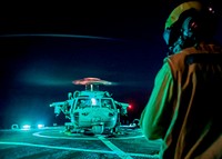170103-N-CS953-008.<br/><br/>ARABIAN SEA (Jan. 3, 2017) Boatswain's Mate 2nd Class Jarret Hal signals as crew remove chocks and chains from a MH-60S Sea Hawk helicopter from Helicopter Sea Combat Squadron 26 as it prepares to lift-off the flight deck of Arleigh Burke-class guided-missile destroyer USS Mahan (DDG 72) during flight operations.