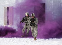 New Jersey Army National Guard Soldiers from the 1-114 Infantry run through smoke after capturing a high value target during a joint training exercise on Joint Base McGuire-Dix-Lakehurst, N.J., Jan. 10, 2017. The Marine Corps Reserve provided airlift and close air support to Alpha Company soldiers of 1-114. The 1-114, which is part of the 50th Infantry Brigade Combat Team, is participating in a series of training events that will culminate this summer at an eXportable Combat Training Capability exercise on Fort Pickett, Va. The Army National Guard’s eXportable Combat Training Capability program is an instrumented Brigade field training exercise designed to certify Platoon proficiency in coordination with First Army. (U.S. Air National Guard photo by Tech. Sgt. Matt Hecht/Released). Original public domain image from Flickr