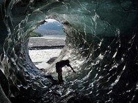 Glacier Features: Ice Cave, Glacier Bay National Park. NPS Photo. Exploring a glacier ice cave, like a channel for water that once flowed through the ice, at Glacier Bay National Park (Alaska). Original public domain image from Flickr