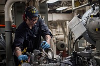 U.S.Navy Engineman 3rd Class Scotty Engelhard, from Lake St. Louis, Mo., works on a lube oil purifier in the main machinery room aboard the amphibious transport dock USS Green Bay (LPD 20), March 27, 2017.