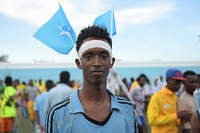 A youth with Somali flag on his head at a ceremony to mark International Sports Day for development and peace in Mogadishu on April 06, 2017. UN Photo / Ilyas Ahmed. Original public domain image from Flickr